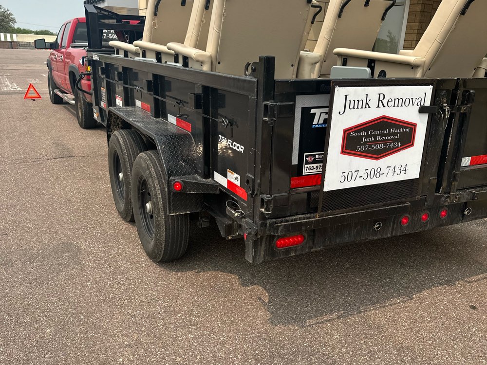 The South Central Hauling and Junk Removal pickup truck and dump trailer on a job